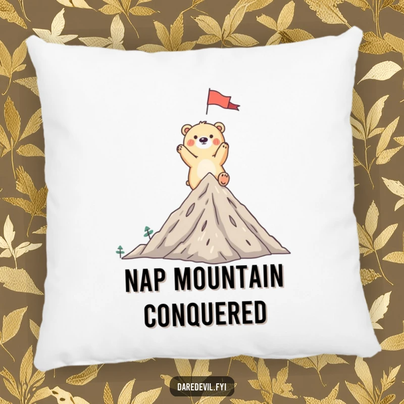 Funny bear pillow featuring a whimsical bear triumphantly planting a flag on a tiny mountain peak, celebrating achievement.
