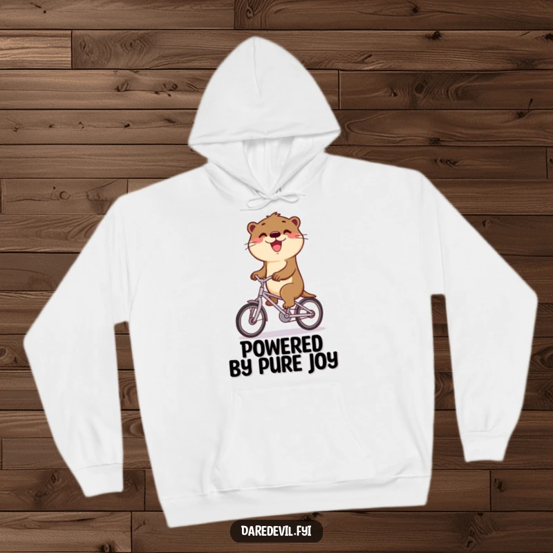 Funny otter rides a bicycle with a wide smile, representing victory and happiness on a funny hoodie.