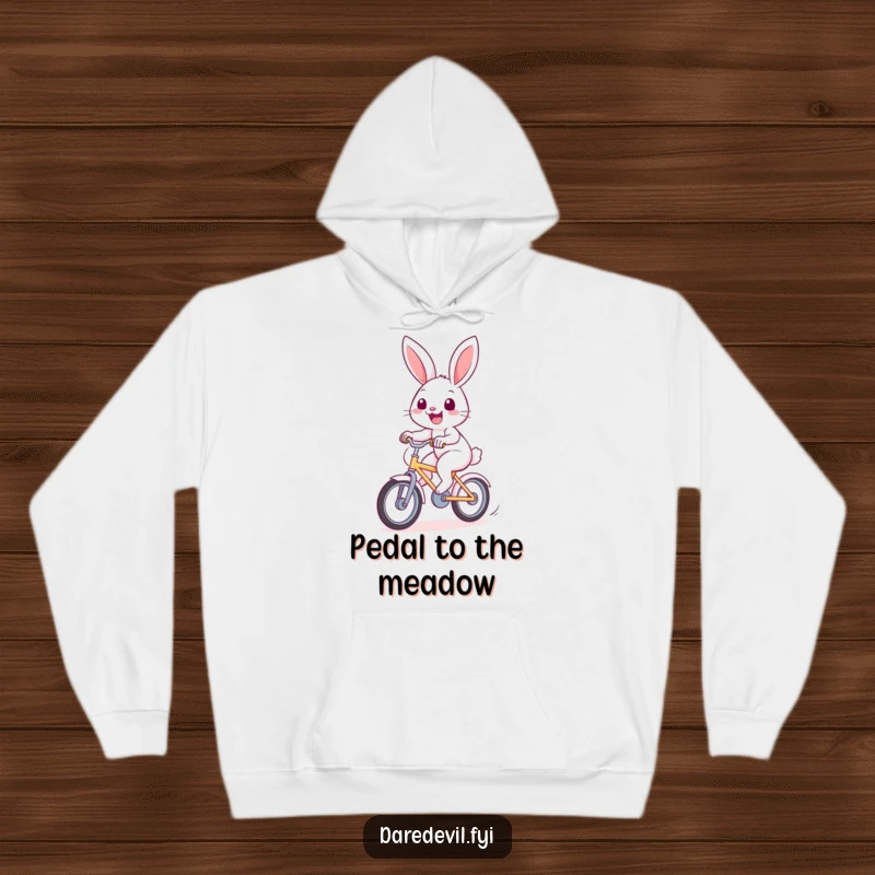Funny rabbit hoodie featuring a cheerful bunny riding a fast bicycle with a wide smile, cozy and humorous.