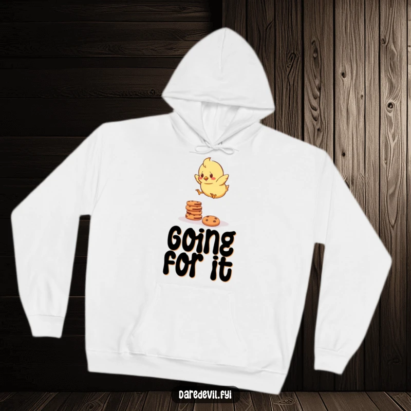 Funny Hoodie featuring a determined chick bravely attempting to jump over a stack of cookies, combining warmth with ambitious humor.